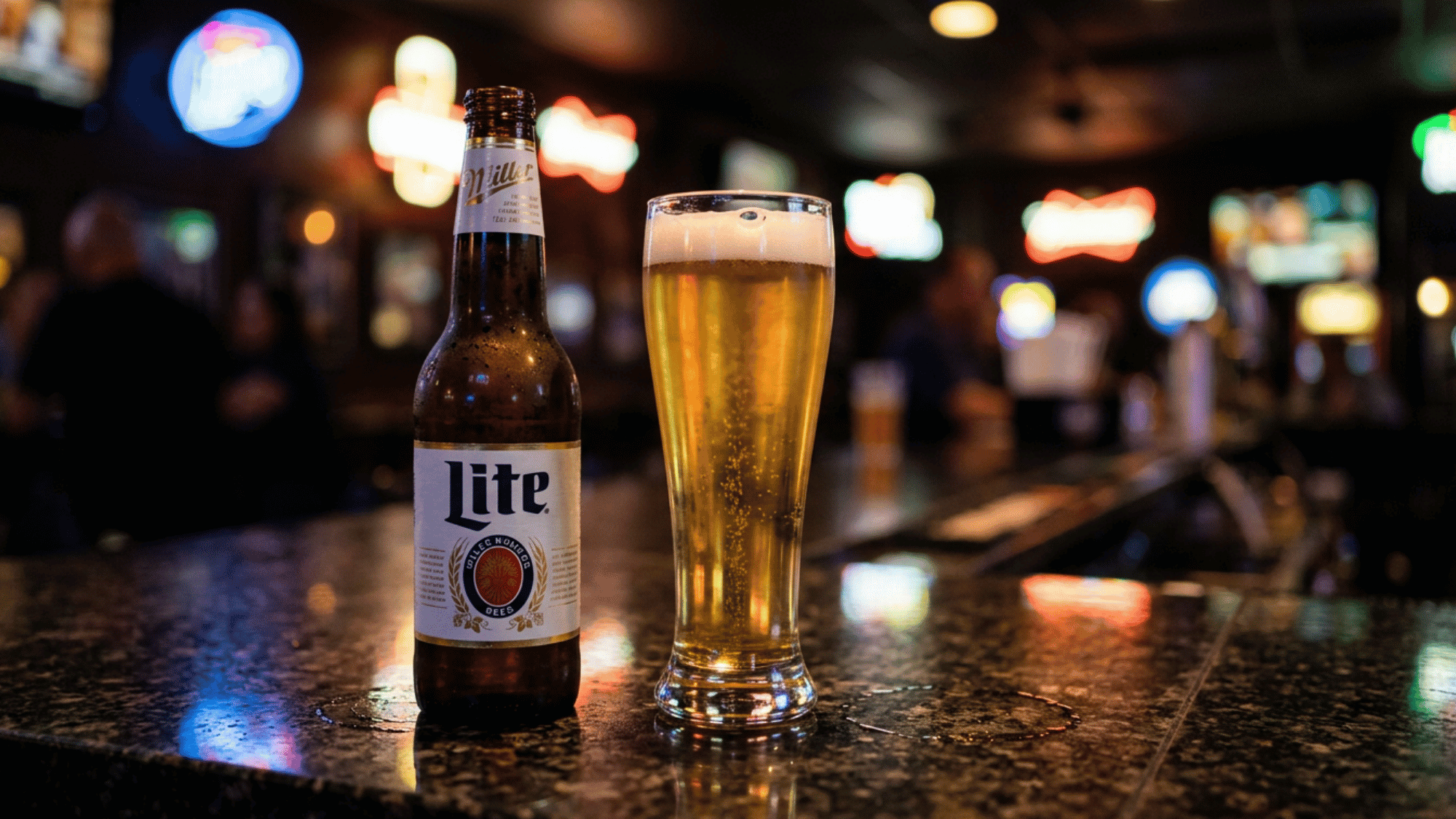 Miller Lite bottle and pilsner glass on a dark bar with neon lights