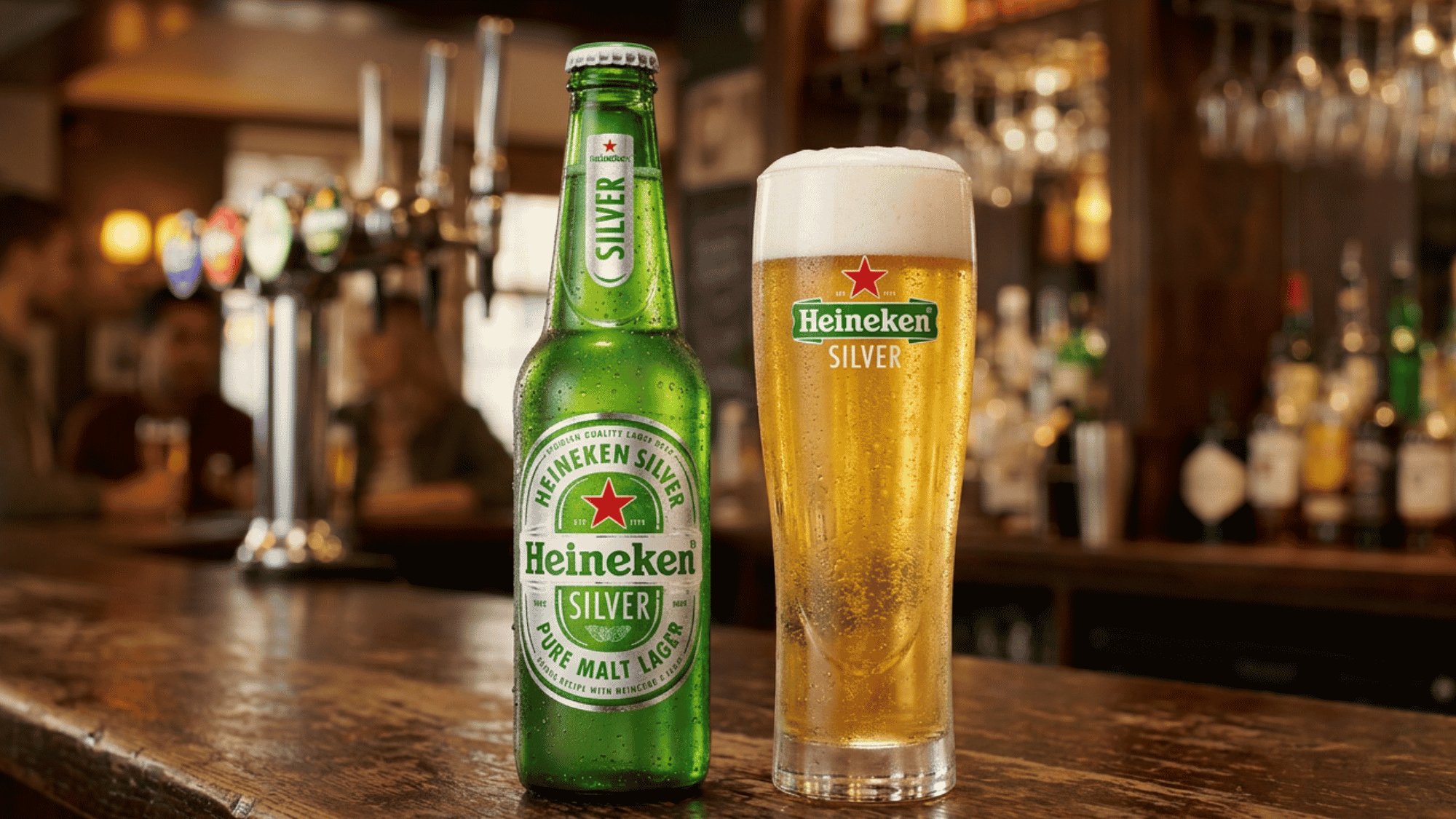 erfectly poured pint of golden lager beside a green beer bottle on a dark pub bar