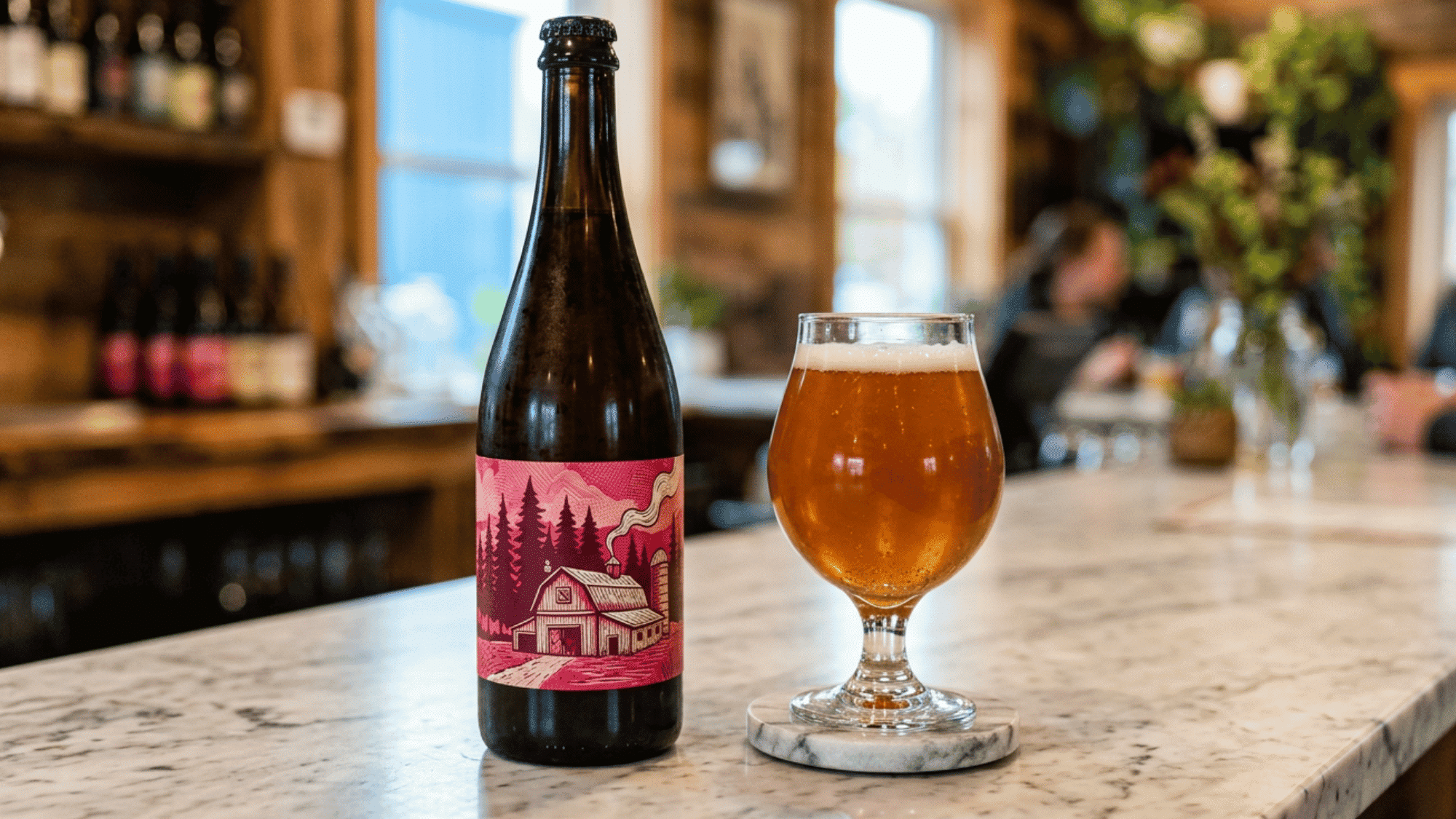 Farmhouse ale bottle and filled beer glass on a bar counter, highlighting traditional craft beer service.