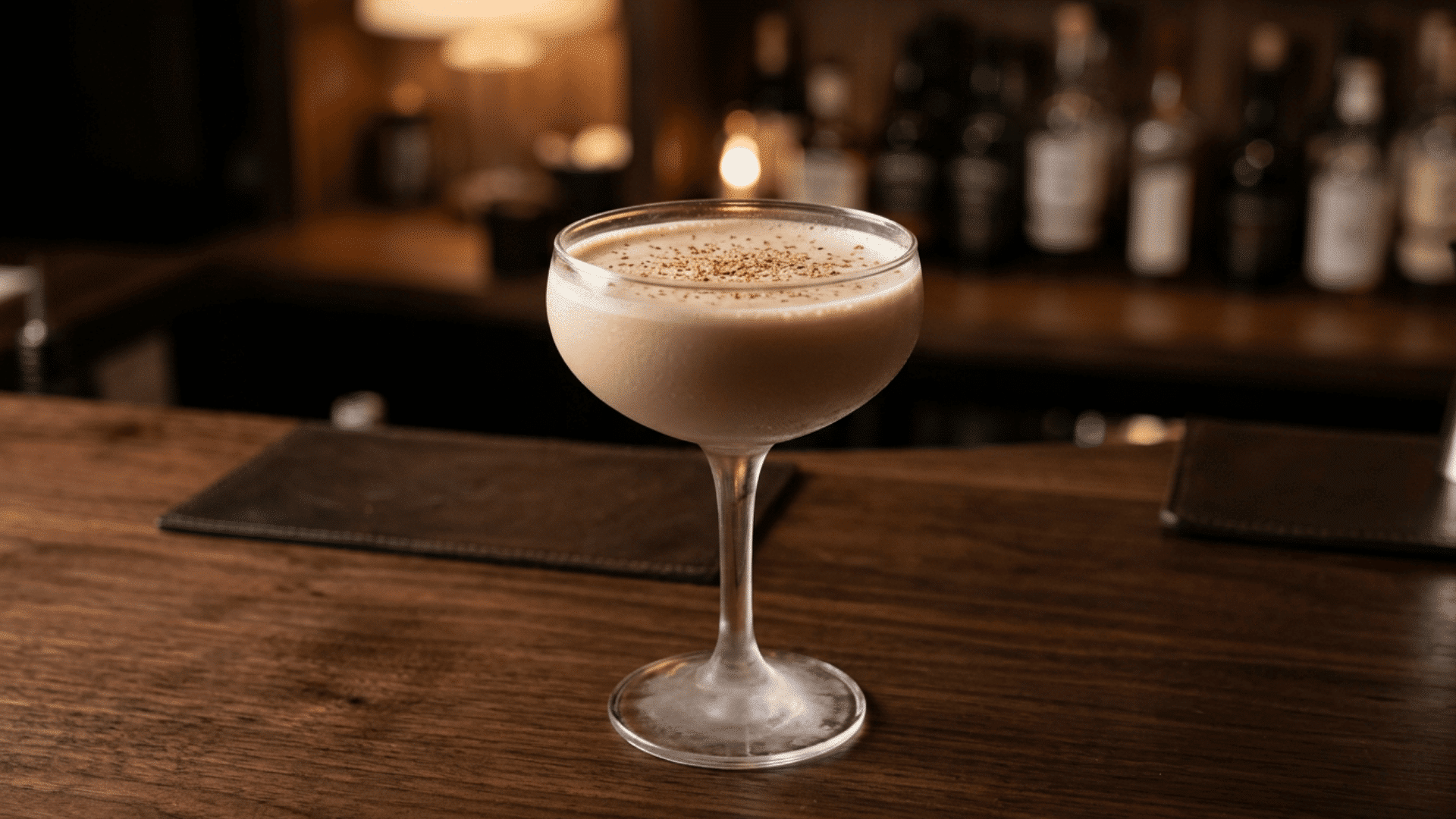 Brandy Alexander cocktail in a coupe glass with grated nutmeg on top.