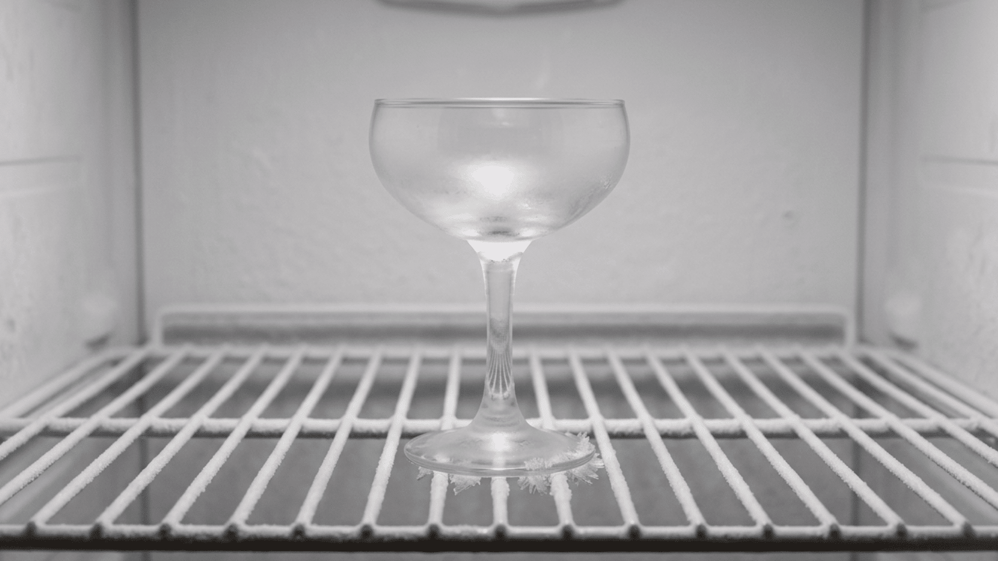 Chilling a coupe glass in the freezer before mixing a classic margarita.
