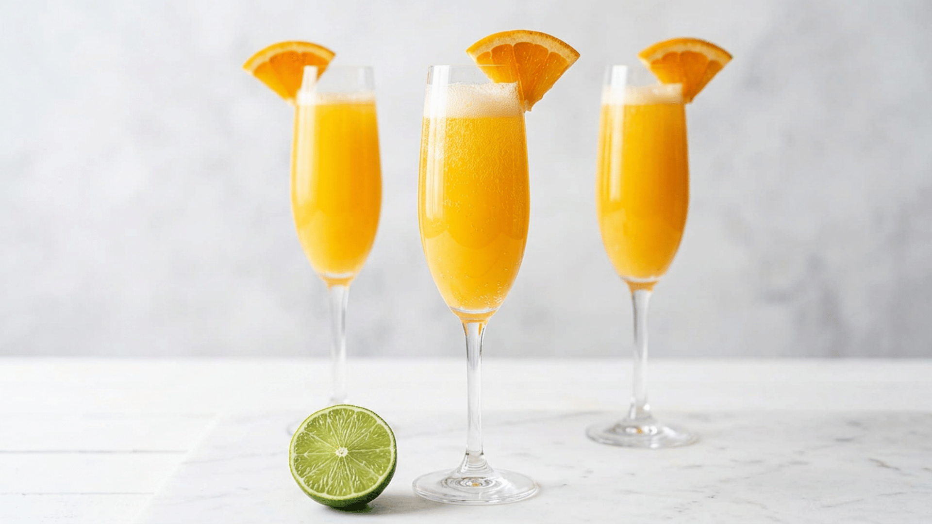 Classic mimosa in a champagne flute with orange slice garnish