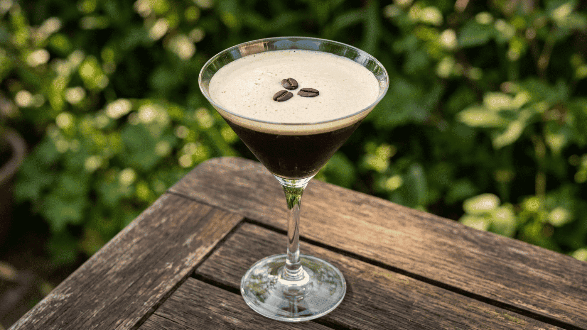 Espresso Martini with coffee foam and beans in a martini glass