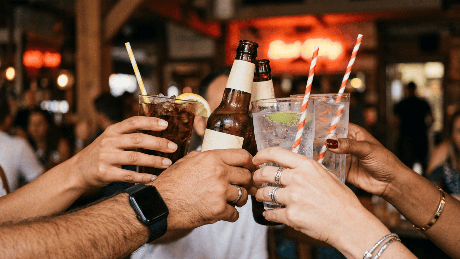 people doing cheers with several alcoholic and non-alcoholics drinks