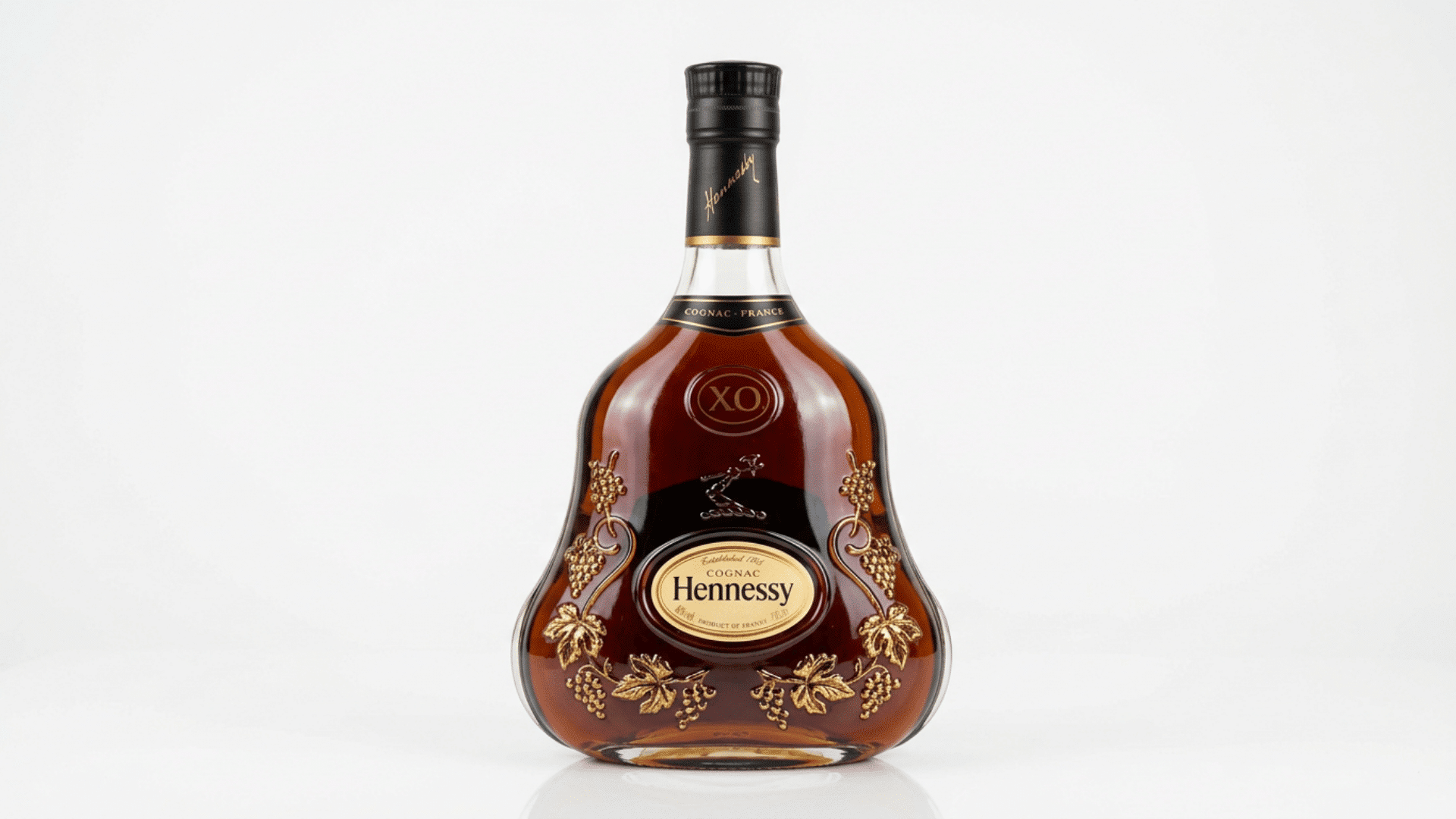 hennessy x.o cognac bottle on a plain background