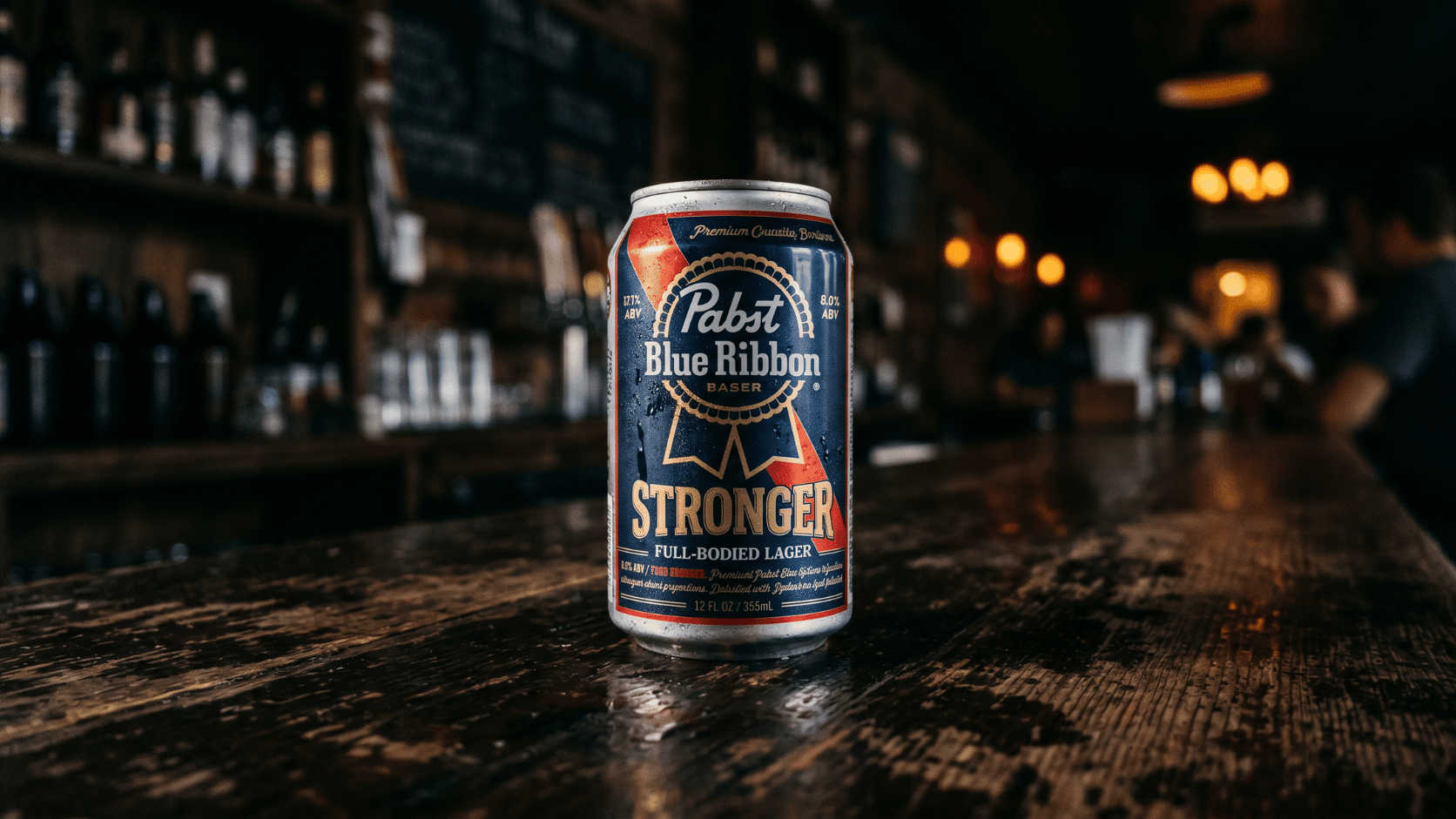 A dark 12-ounce can of Pabst Blue Ribbon Higher-ABV variant beer against a bar background.