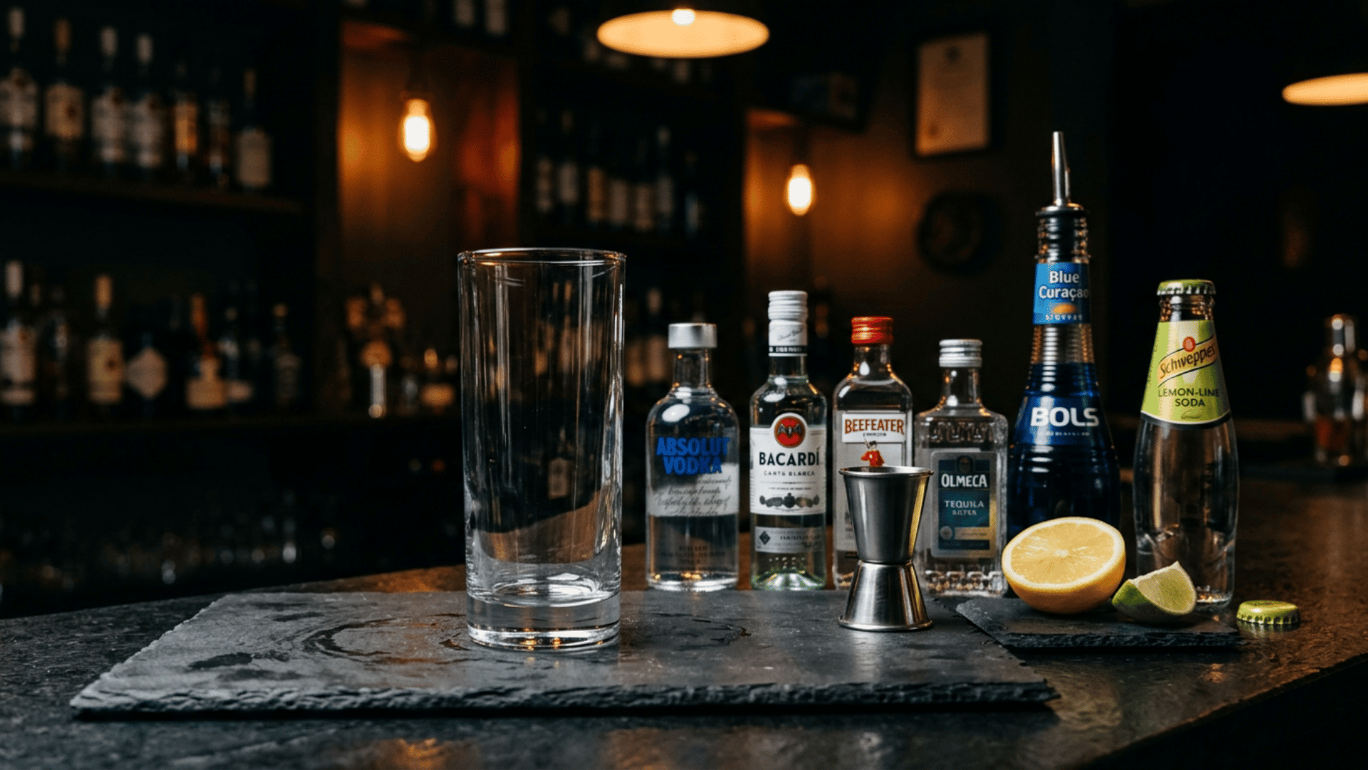 Tall highball glass and AMF cocktail ingredients arranged on a dark bar counter