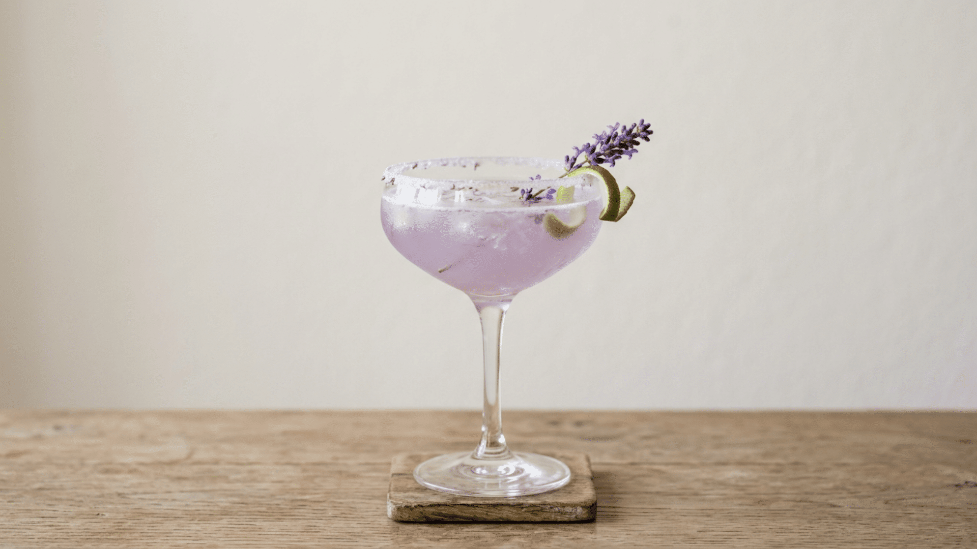 Lavender margarita with pale purple color and lavender sprig garnish