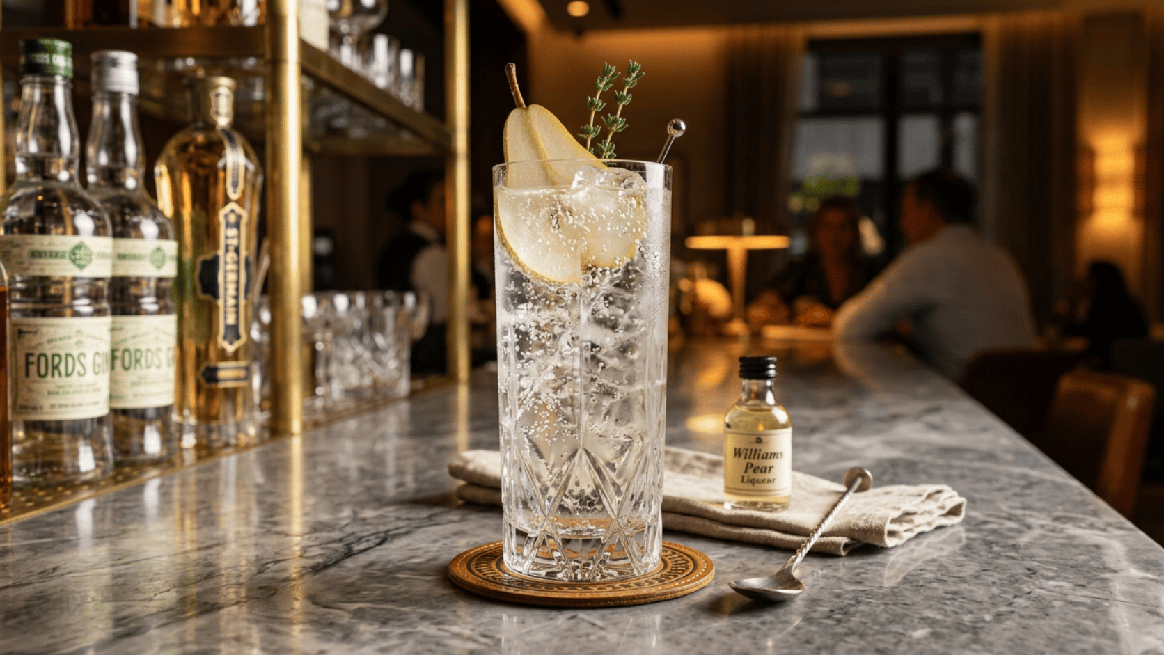 Pear Gin Fizz cocktail in a tall glass over ice, garnished with a fresh pear slice and thyme.