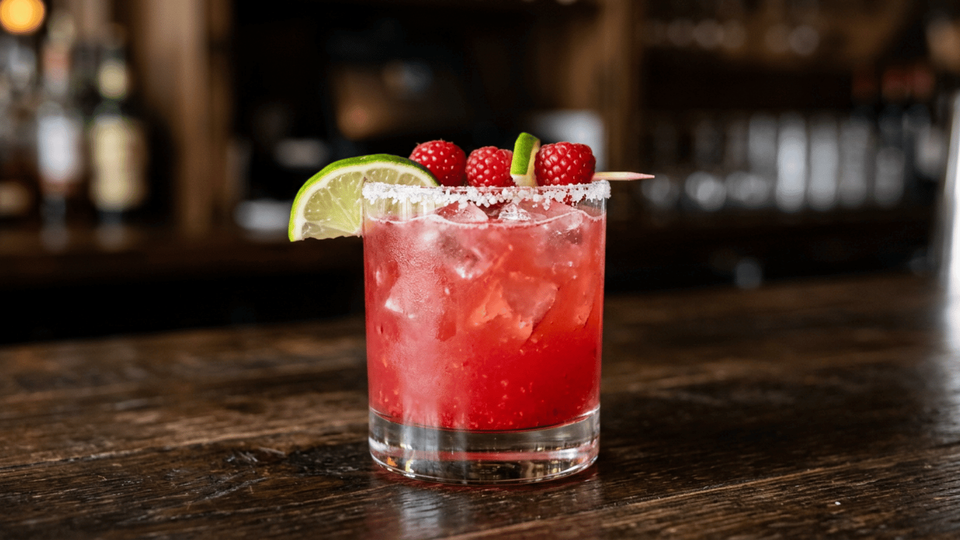 Raspberry margarita with bright red-pink color and raspberry garnish