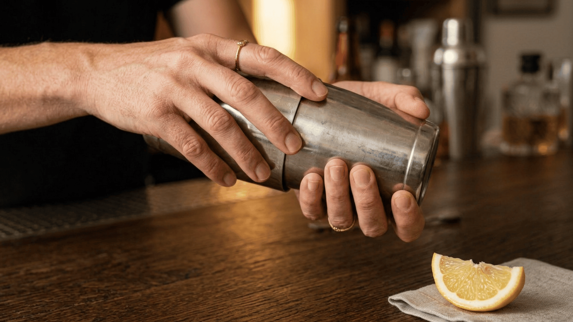 Vigorously shaking a sealed cocktail shaker to chill and mix the ingredients.