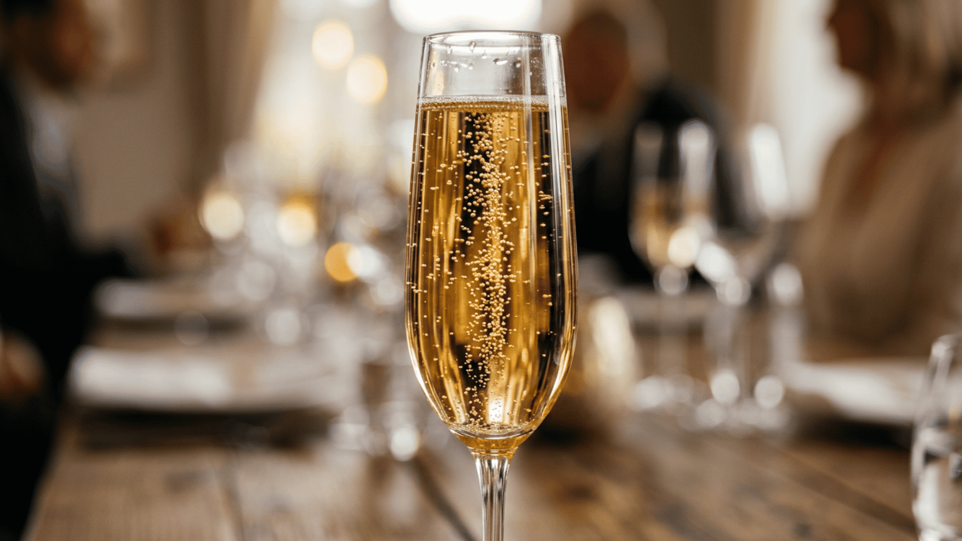 Sparkling wine bubbles rising in flute glass