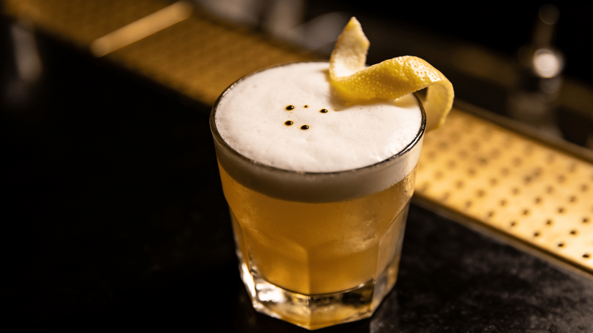 Tequila Sour with foam and bitters dots