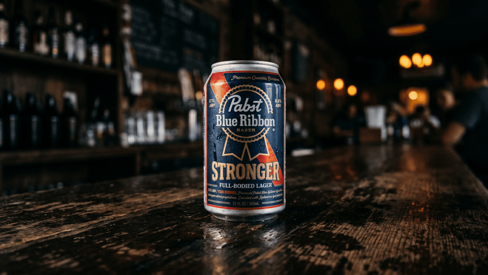A dark 12-ounce can of Pabst Blue Ribbon Higher-ABV variant beer against a bar background.