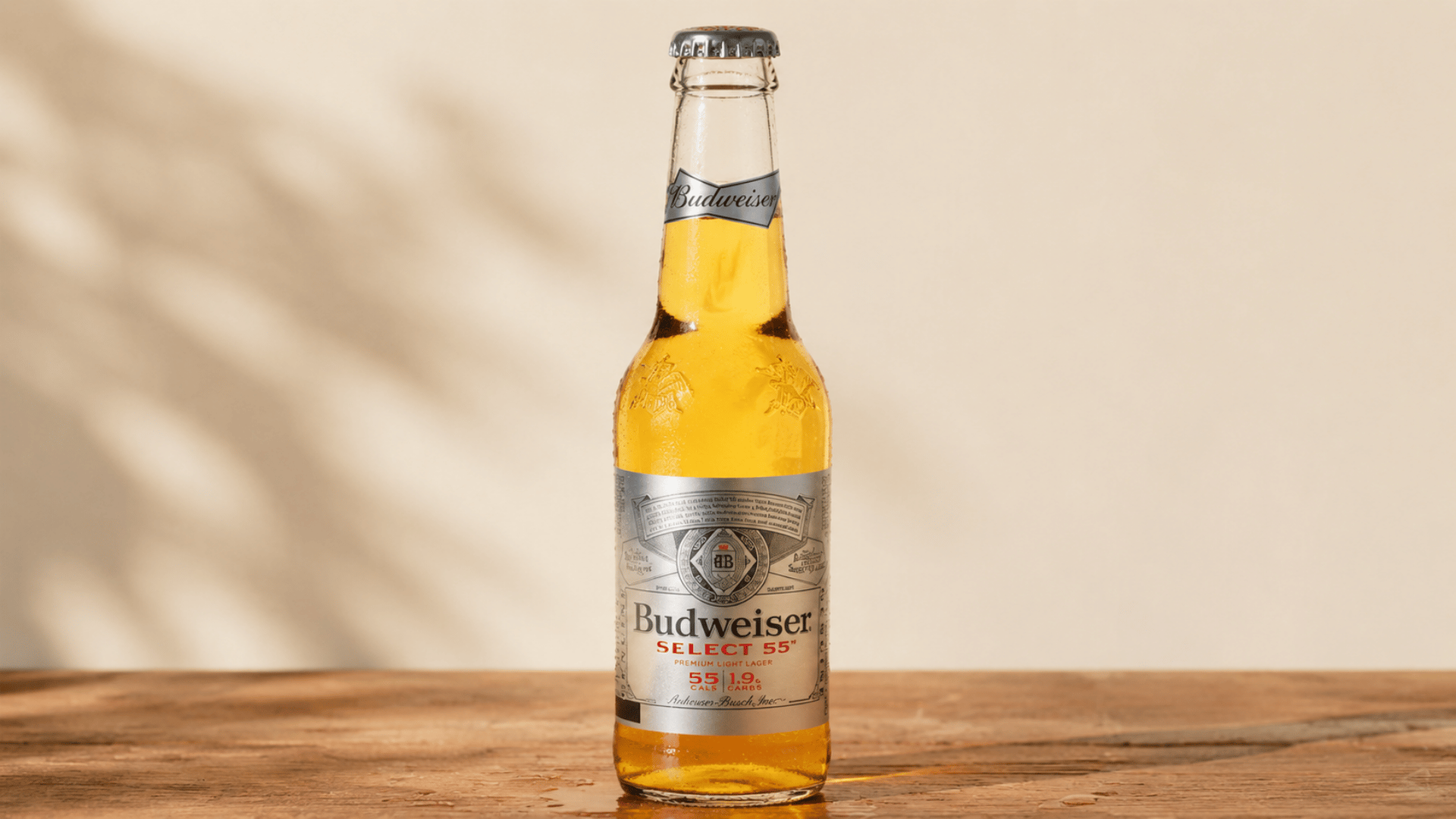 Budweiser Select 55 beer bottle standing on a wooden table.