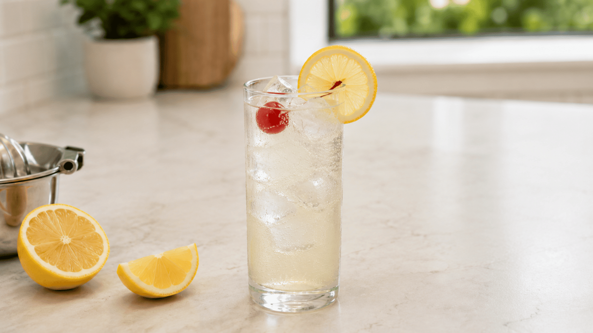 Finished Tom Collins with clear ice, lemon wheel, cherry, and bubbles.
