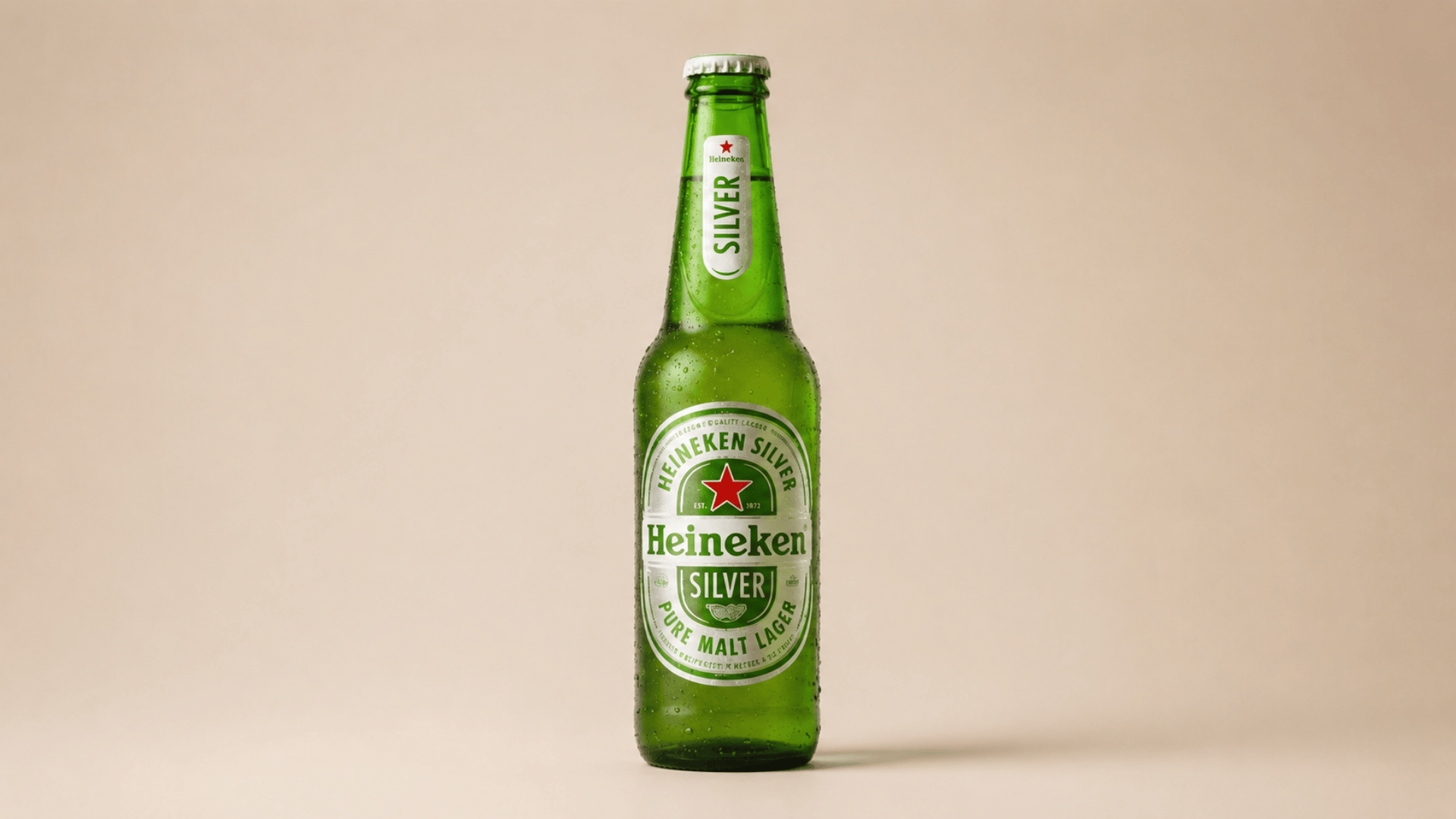 heineken silver beer bottle with green glass on neutral background.