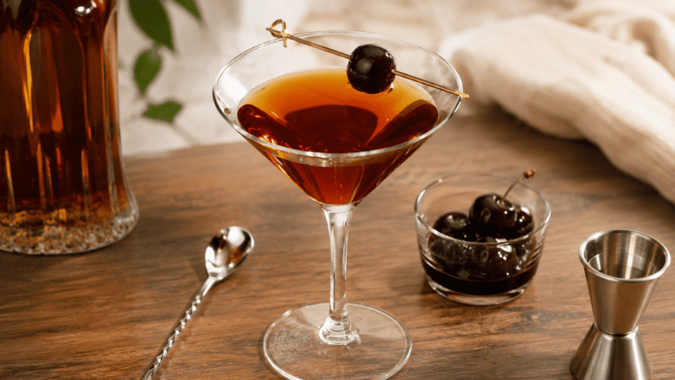 classic manhattan cocktails with orange twists and cherry garnishes