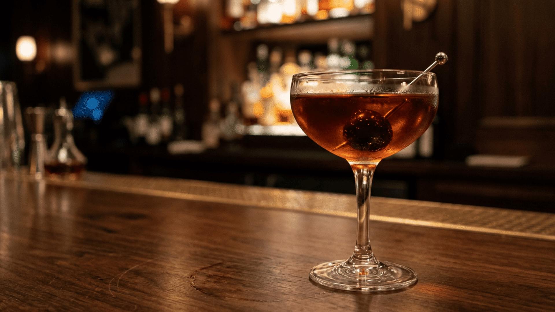 Manhattan cocktail with cherry in coupe glass