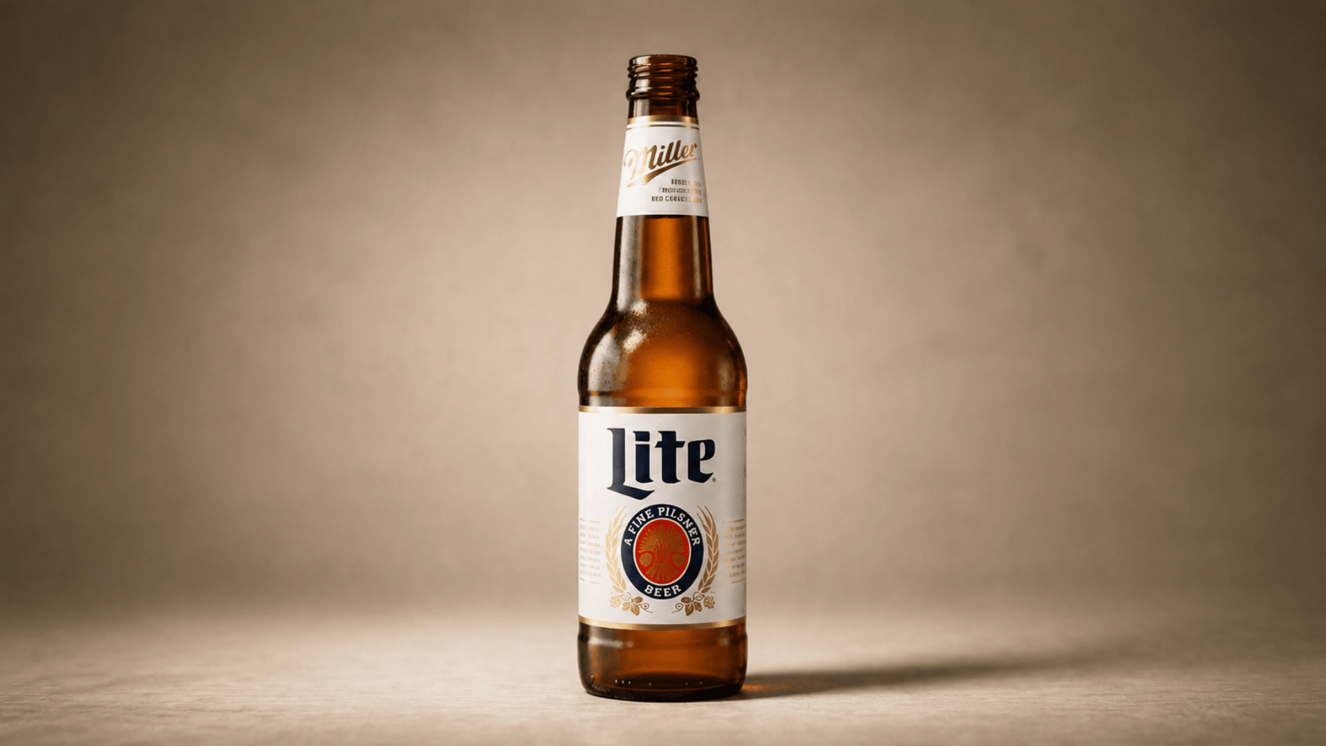 miller lite beer bottle with condensation on dark neutral background.
