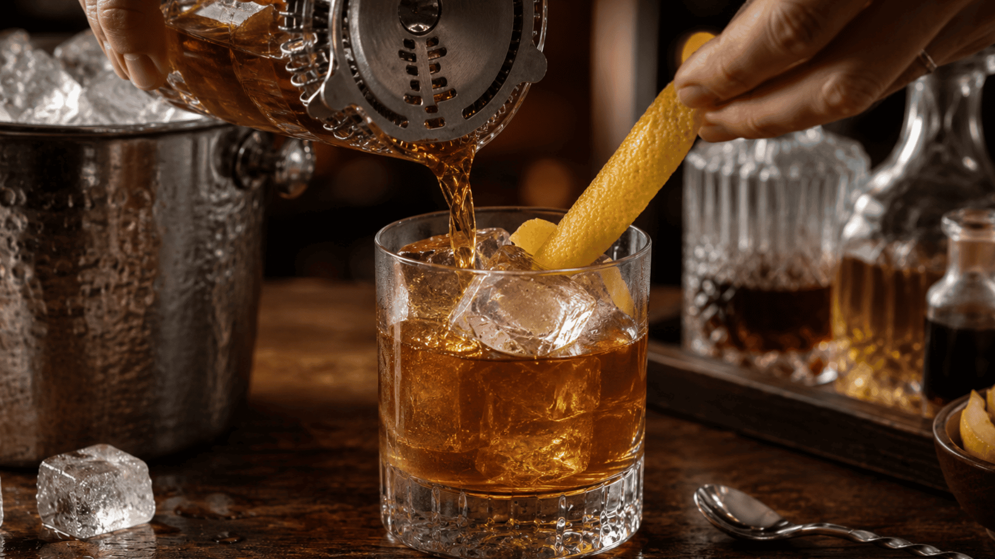 Vieux Carré cocktail strained over ice and garnished with a lemon peel