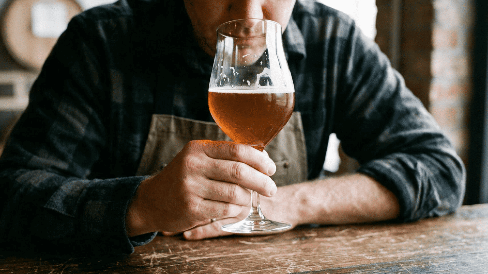 beer taster smelling an amber beer to identify its aromas