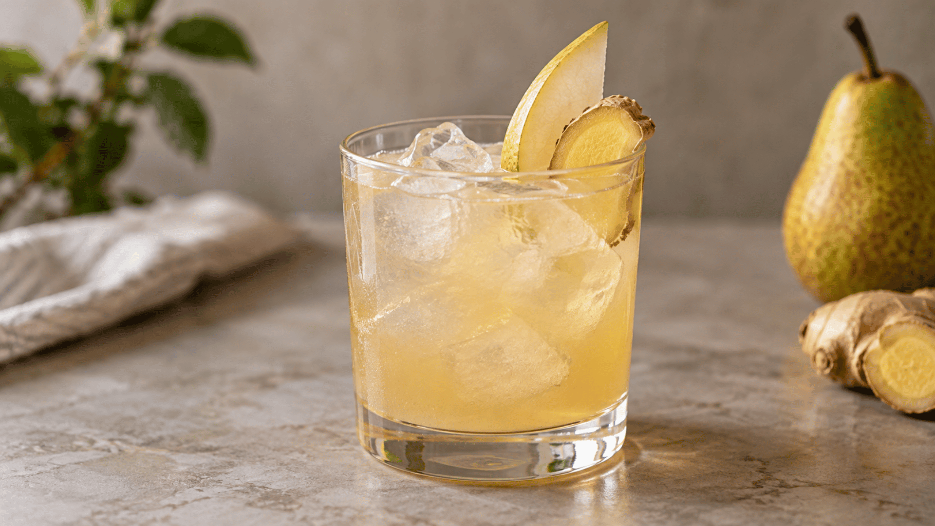 Pear and ginger cocktail over ice with a thin fresh pear slice and ginger garnish