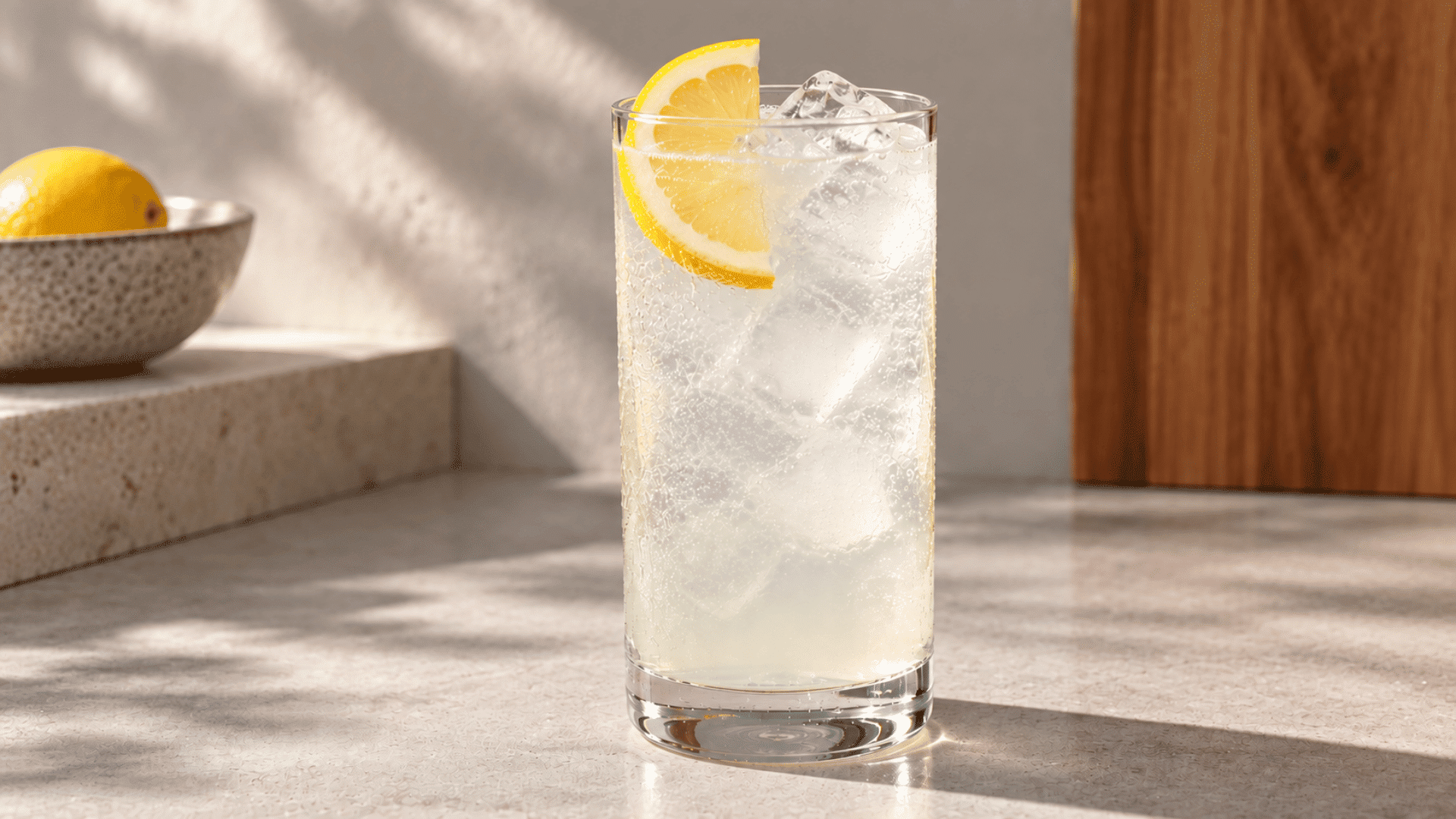 clear ranch water cocktail with ice and lemon garnish in a tall glass