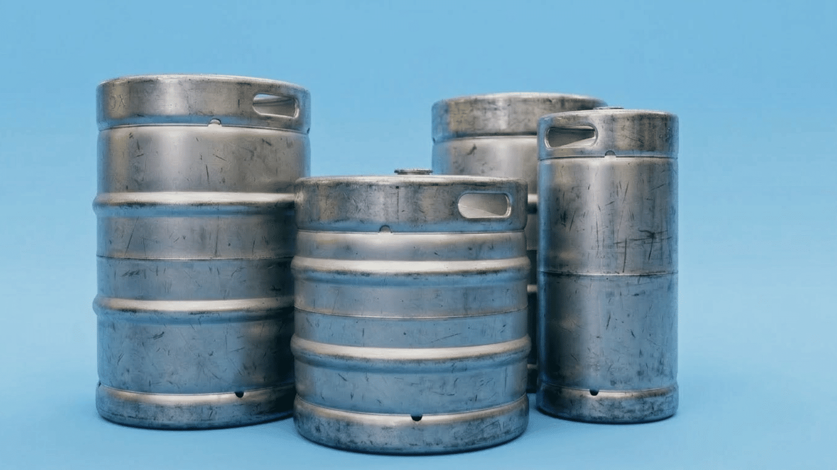 stainless steel beer kegs arranged in a refrigerated liquor store cooler for sale